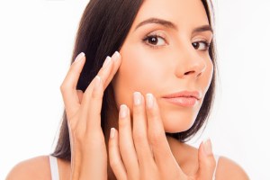 Woman touching her face